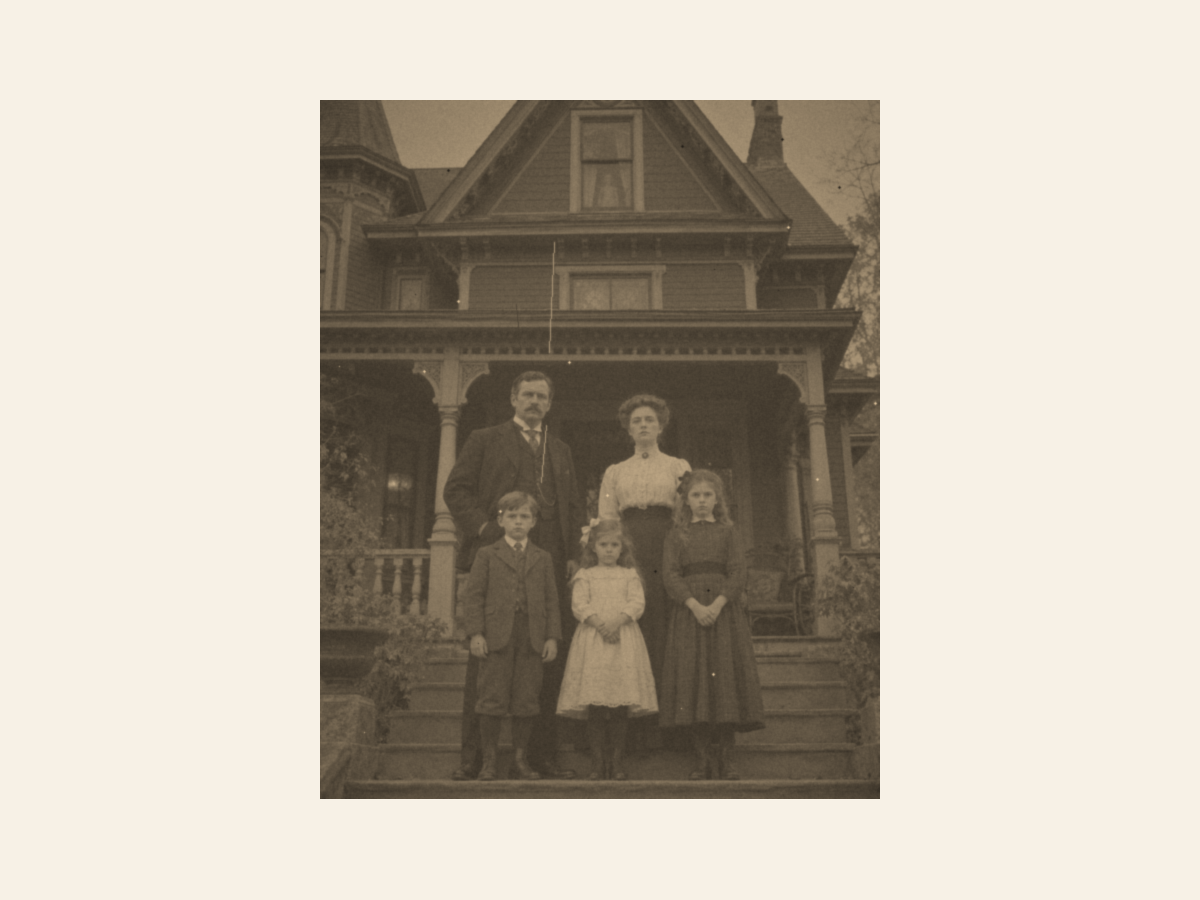 A faded, sepia old family photo in front of a large house, small and soft with scratches.